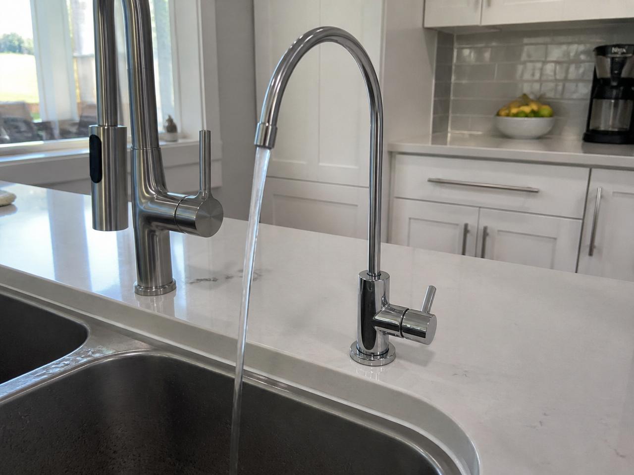 Chrome RO faucet installed on a quartz countertop