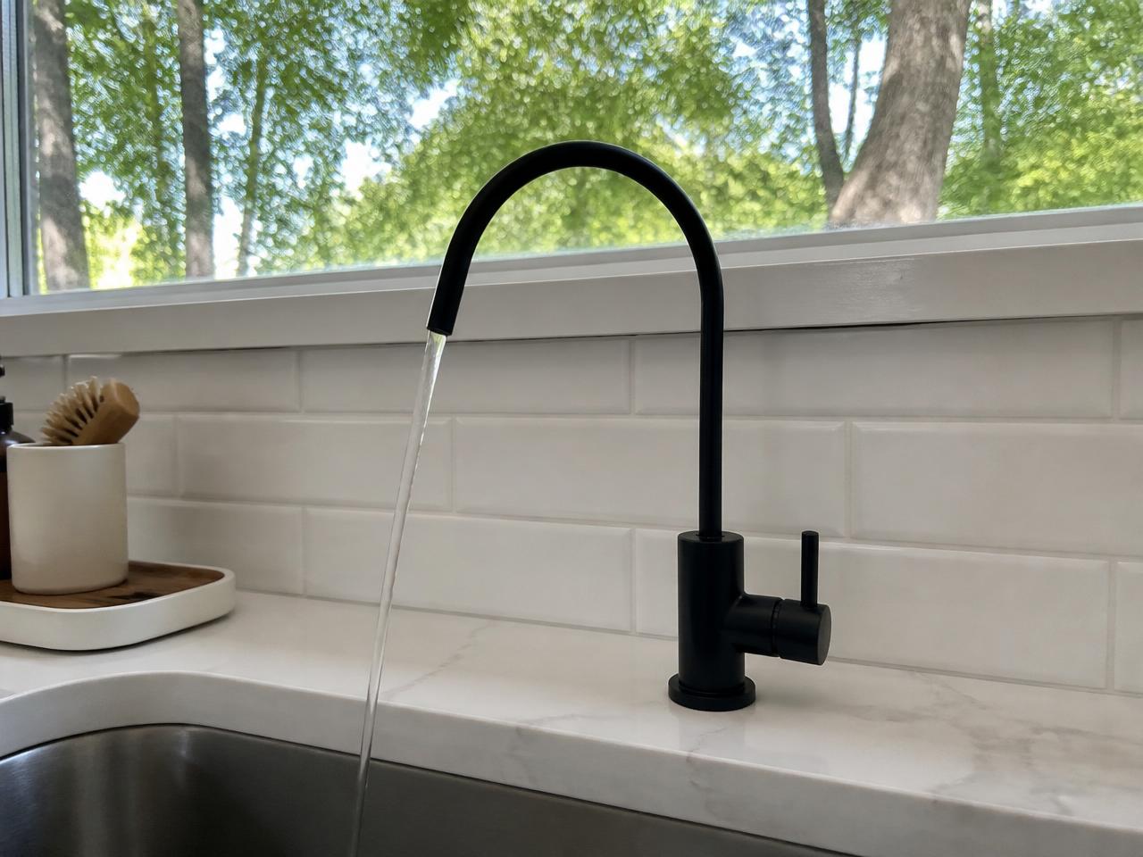 Matte black reverse osmosis faucet in a modern kitchen